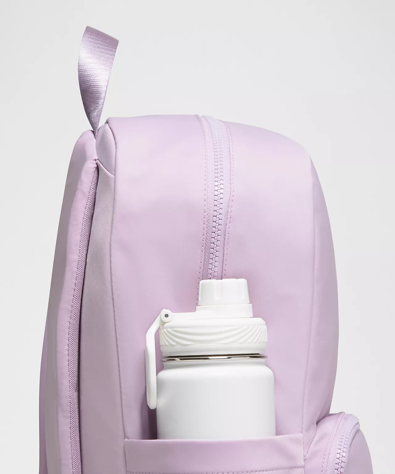Everywhere Backpack 22L in pink showing side bottle pocket